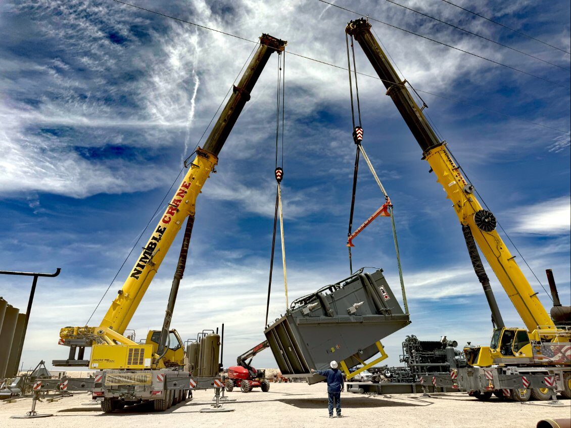 Two Nimble Crane cranes performing a tandem module lift